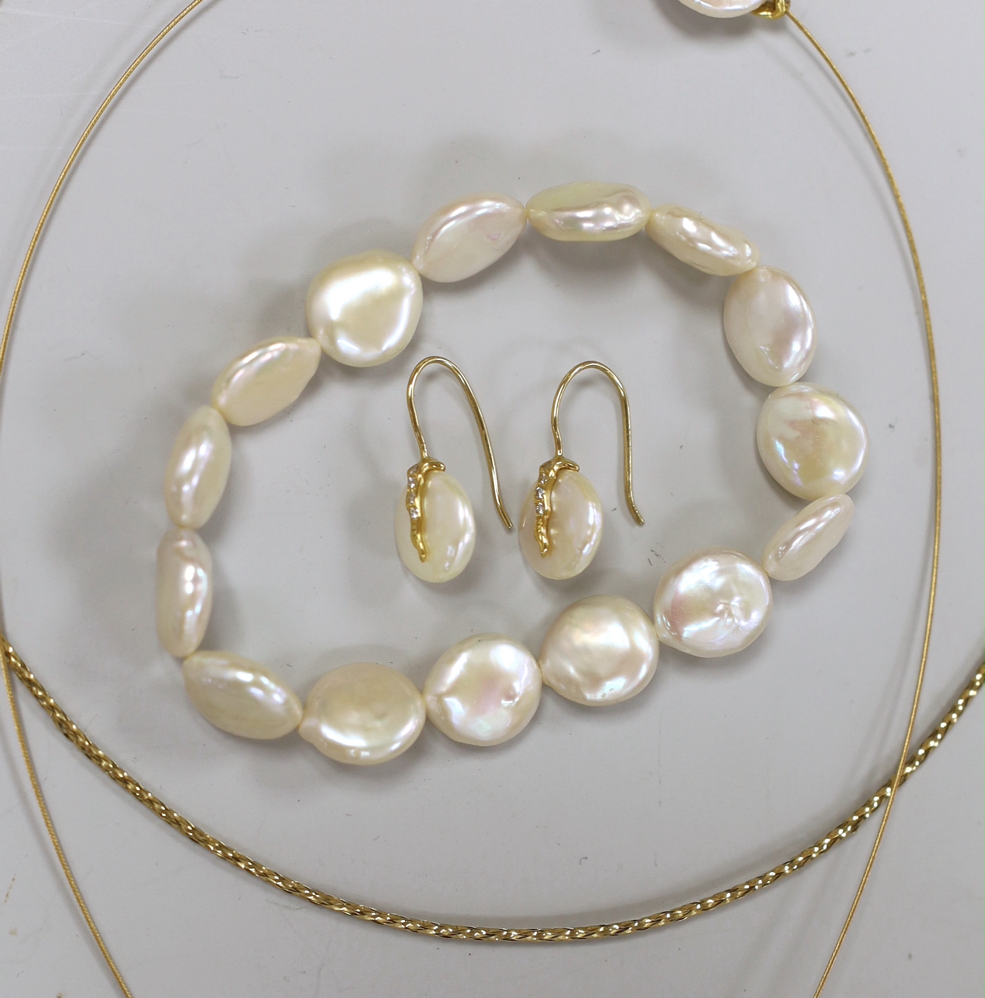 A modern suite of 750, diamond and button cultured pearl set jewellery, comprising a necklet and pair of earrings, together with a mother of pearl bracelet and a 375 necklet.